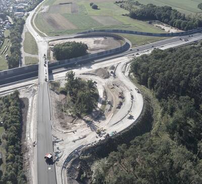 Während der Teilbereich der derzeit gesperrten Staatstraße 2240 zwischen Autobahnbrücke und Gewerbepark bereits neu asphaltiert ist (links unten), dauern die Arbeiten an der A3-Anschlussstelle zur Auffahrt auf die A3 in Richtung Würzburg/Frankfurt vorauss. noch bis 14. September 2025 an. 